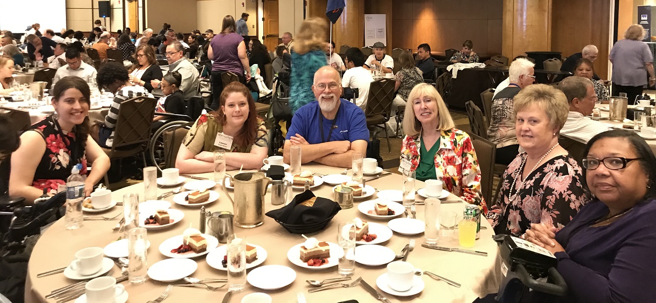 Photo of SILC members and staff enjoying each other’s company during NCIL awards luncheon